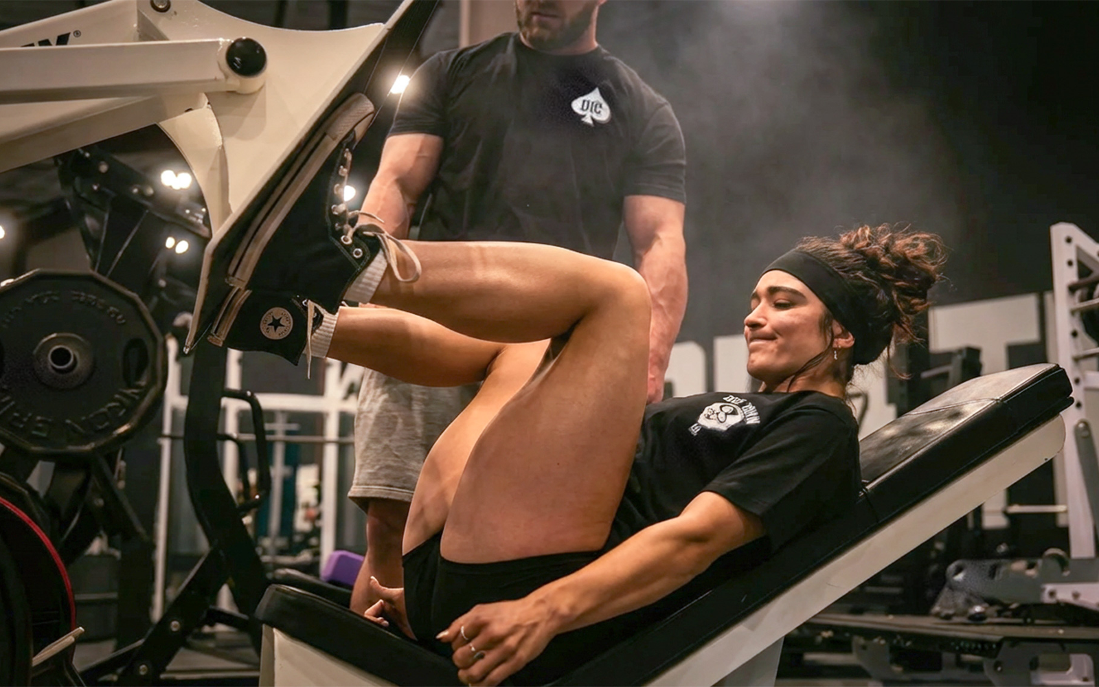 Athlete training hard with food and supplements staged beside the rack