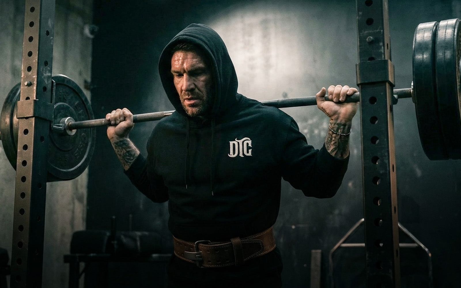 DTC athlete on squat rack wearing DTC hoodie