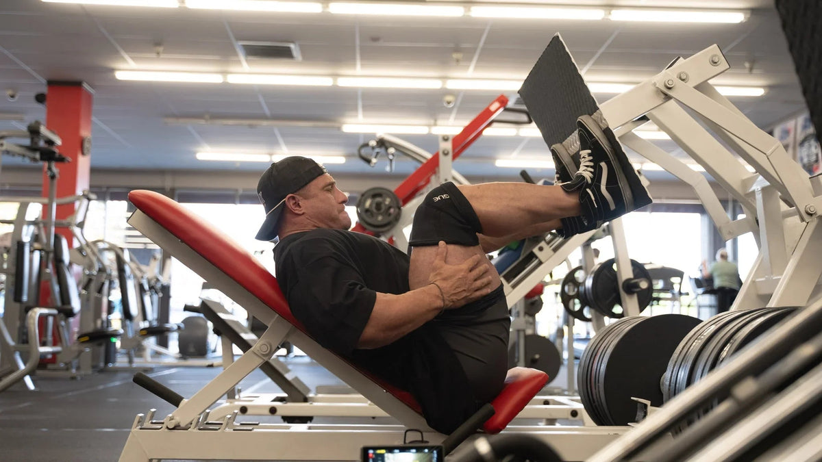 Lifter pressing heavy on the leg press to build quads and hamstrings