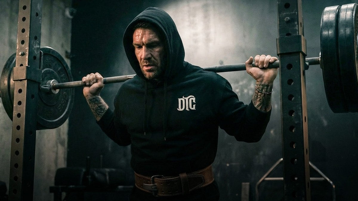 DTC athlete on squat rack wearing DTC hoodie