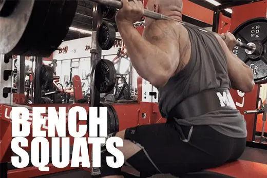 Bench squat at depth — thighs parallel to floor, glutes touching bench
