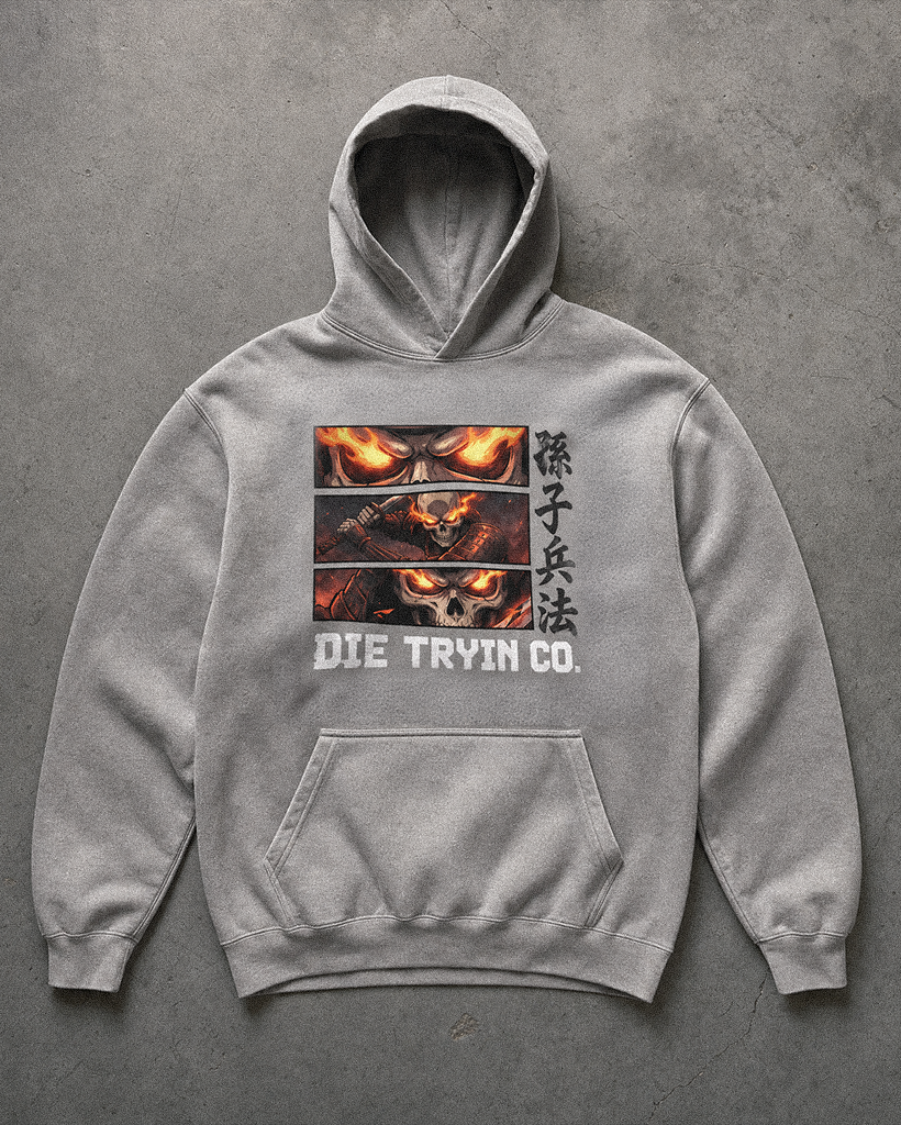 Grey hoodie with three flaming skull panels, Chinese Art of War characters and Die Tryin Co. print, flat lay on concrete