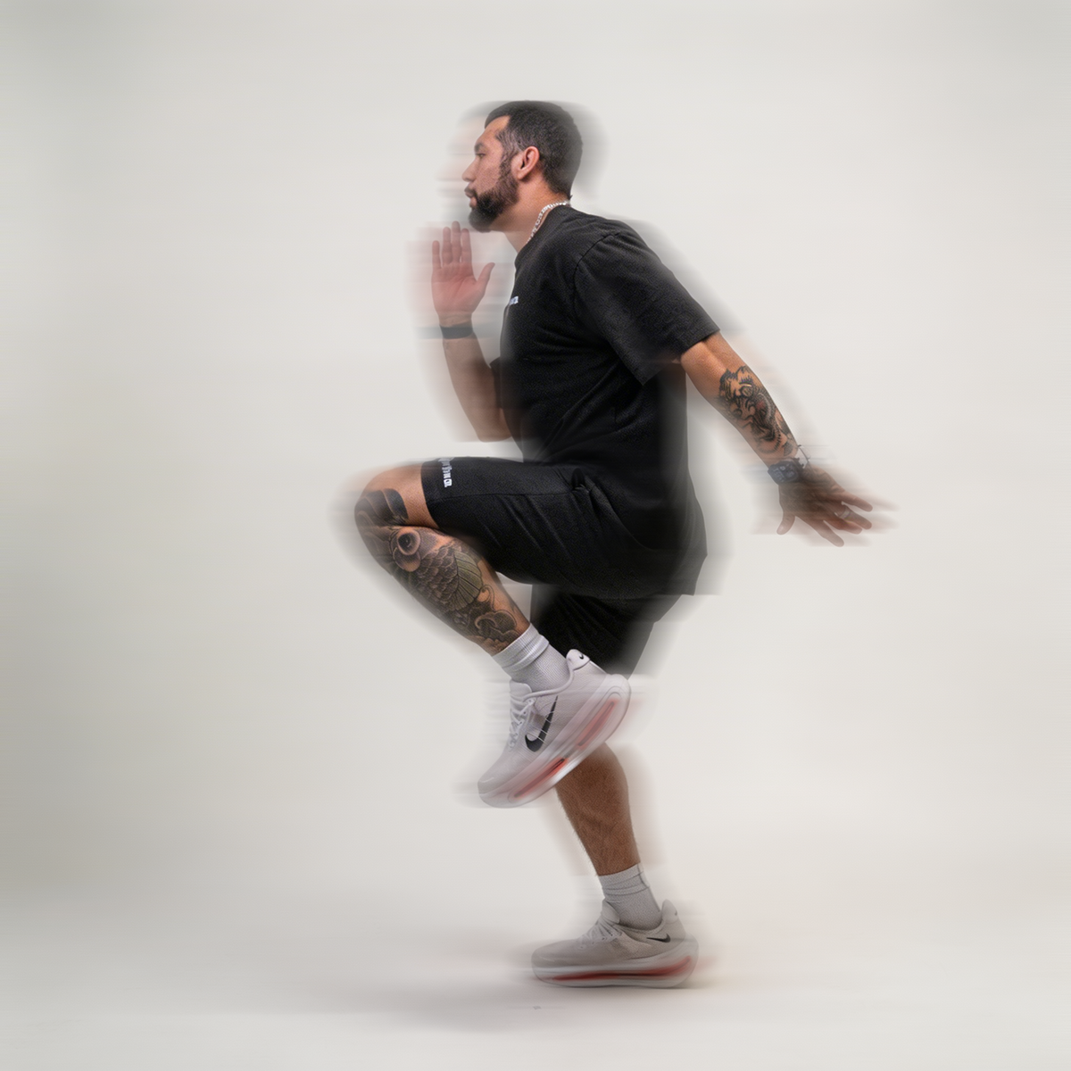 Athlete doing high knees in the Mens Performance shorts, motion shot