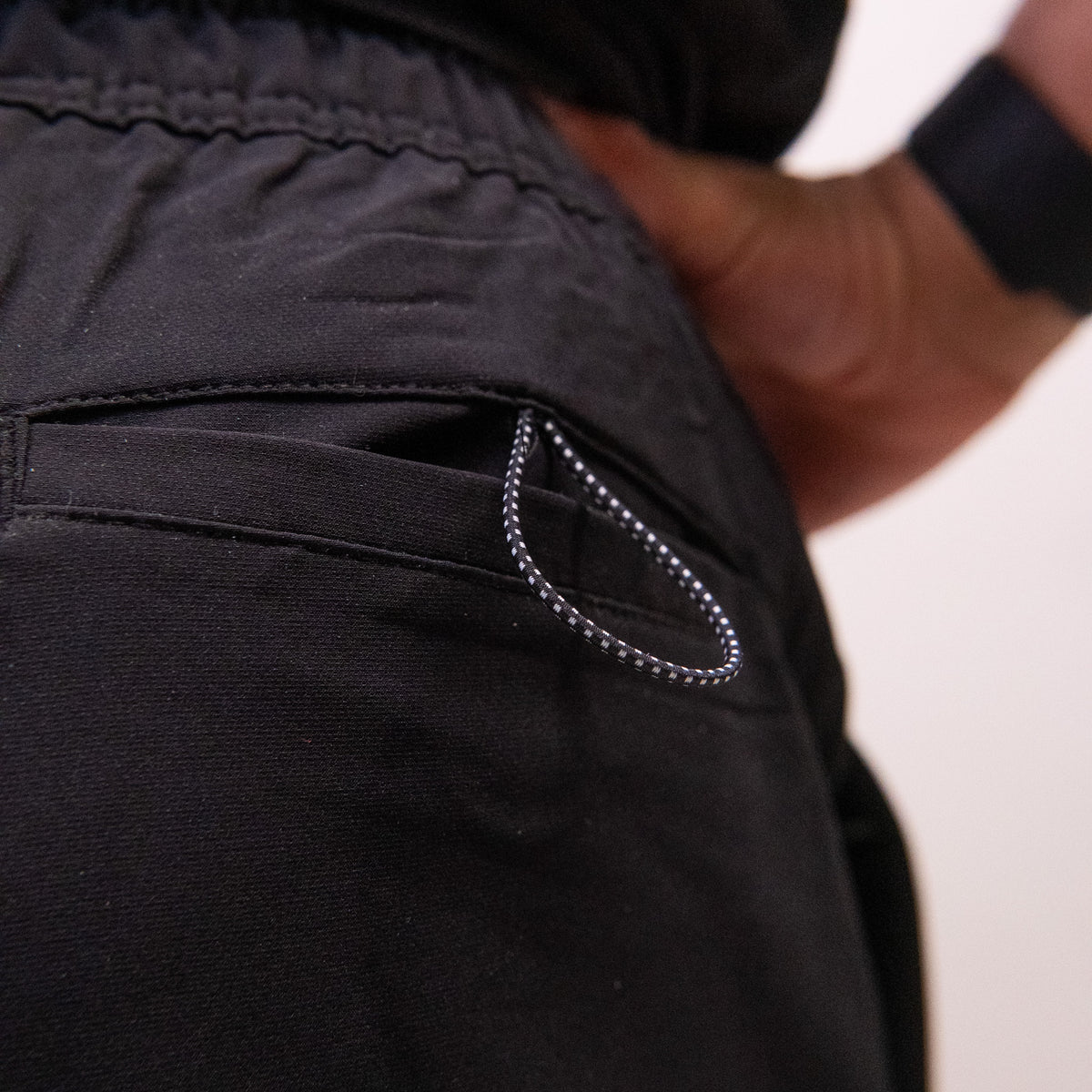 Corded back pocket loop detail on the black Mens Performance shorts
