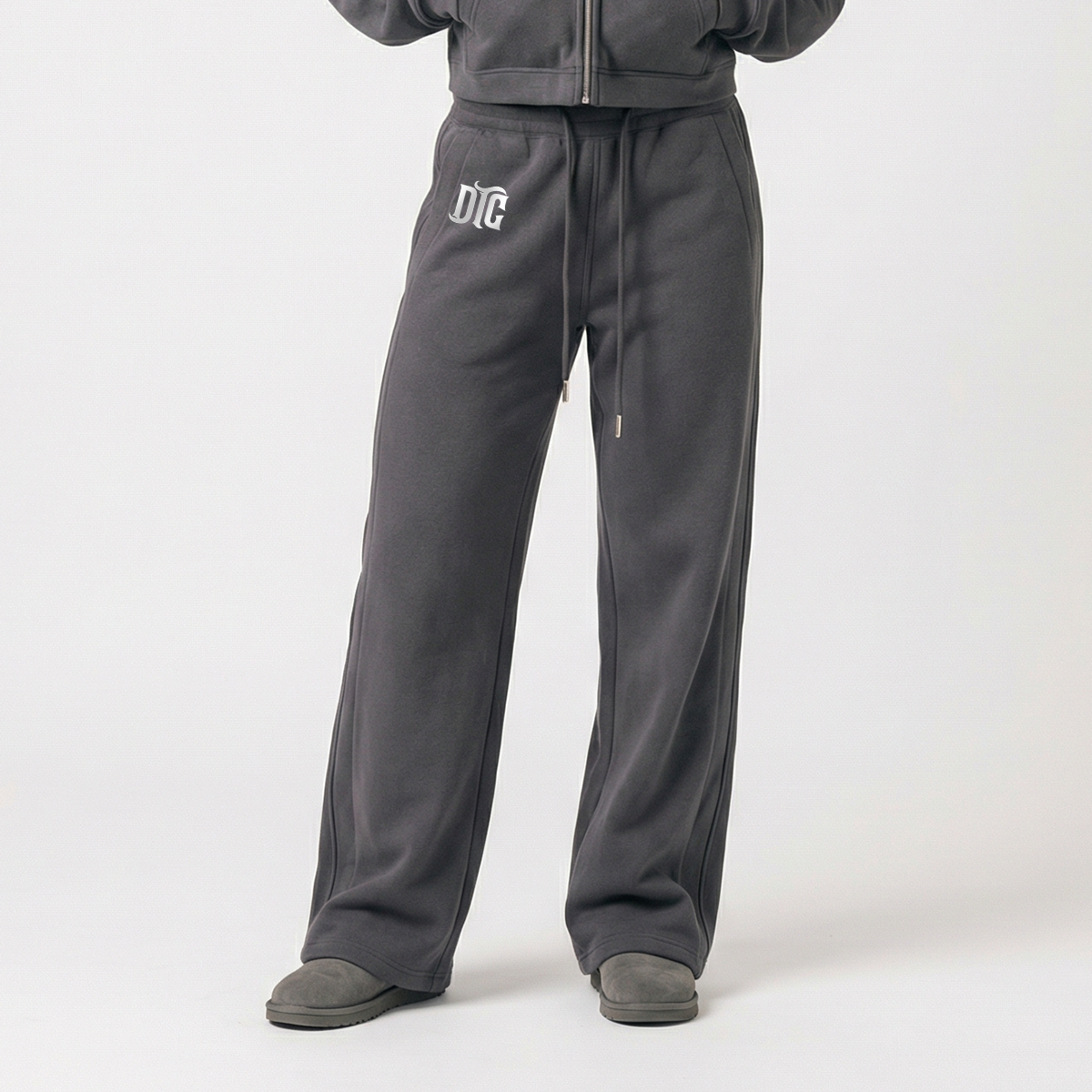 Grey baggie joggers flat lay with DTC leg logo