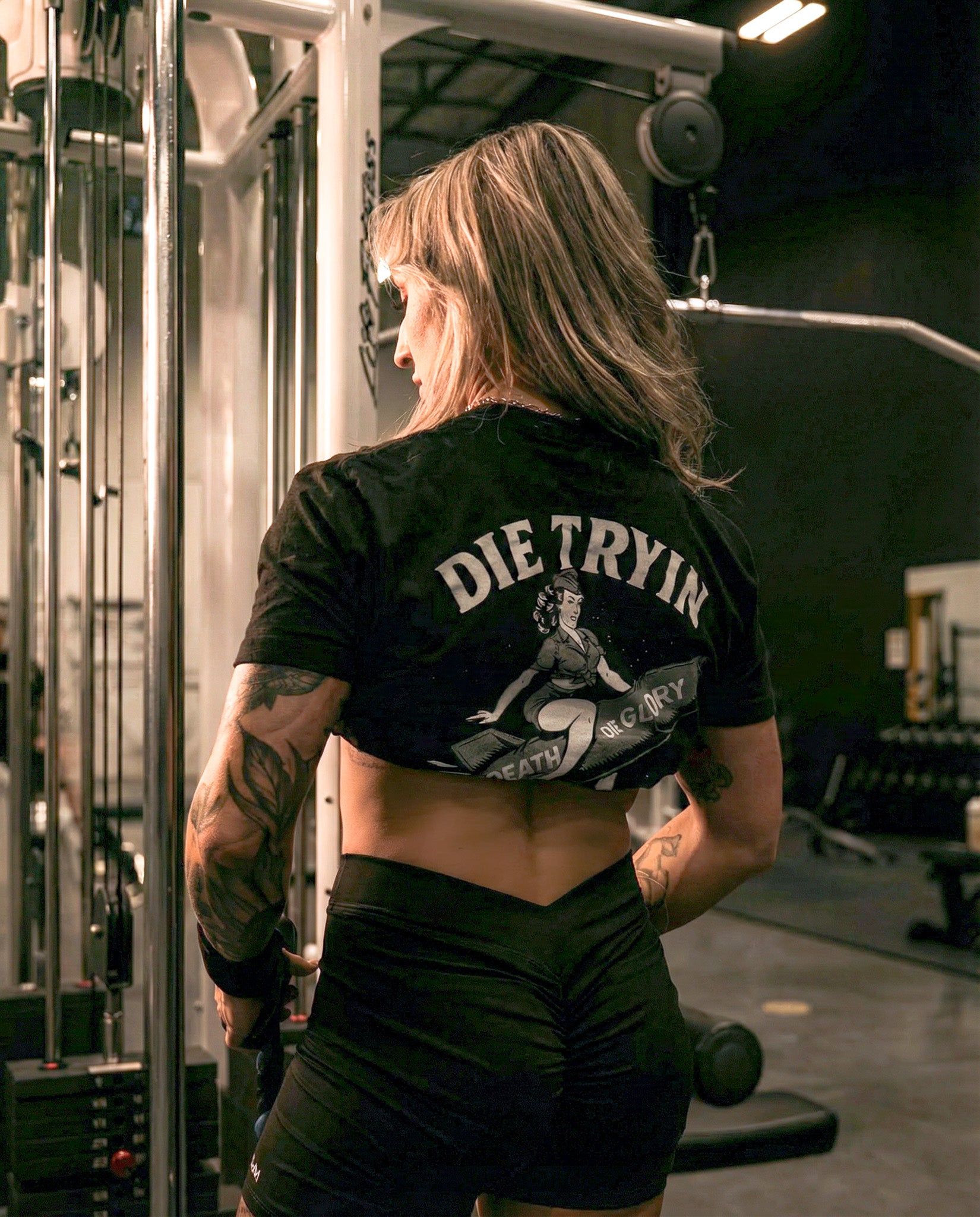Bomber Girl fitted tee back graphic worn at a cable machine