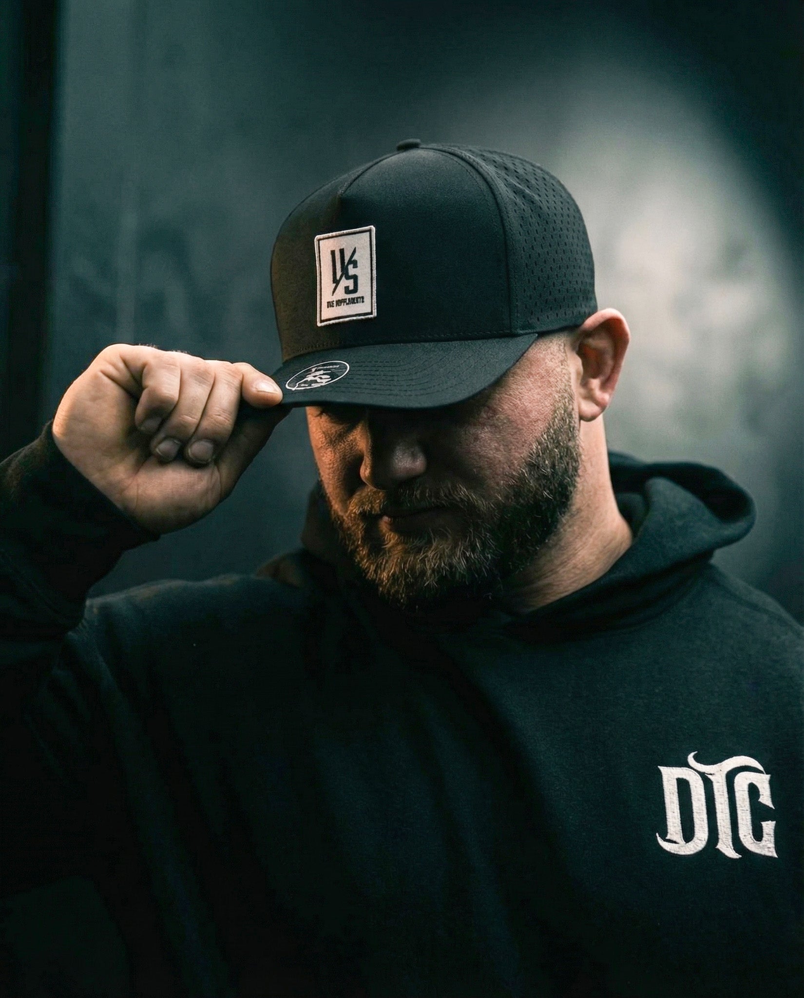 Black PVC-patch hat worn with a Die Tryin Co. zip-up
