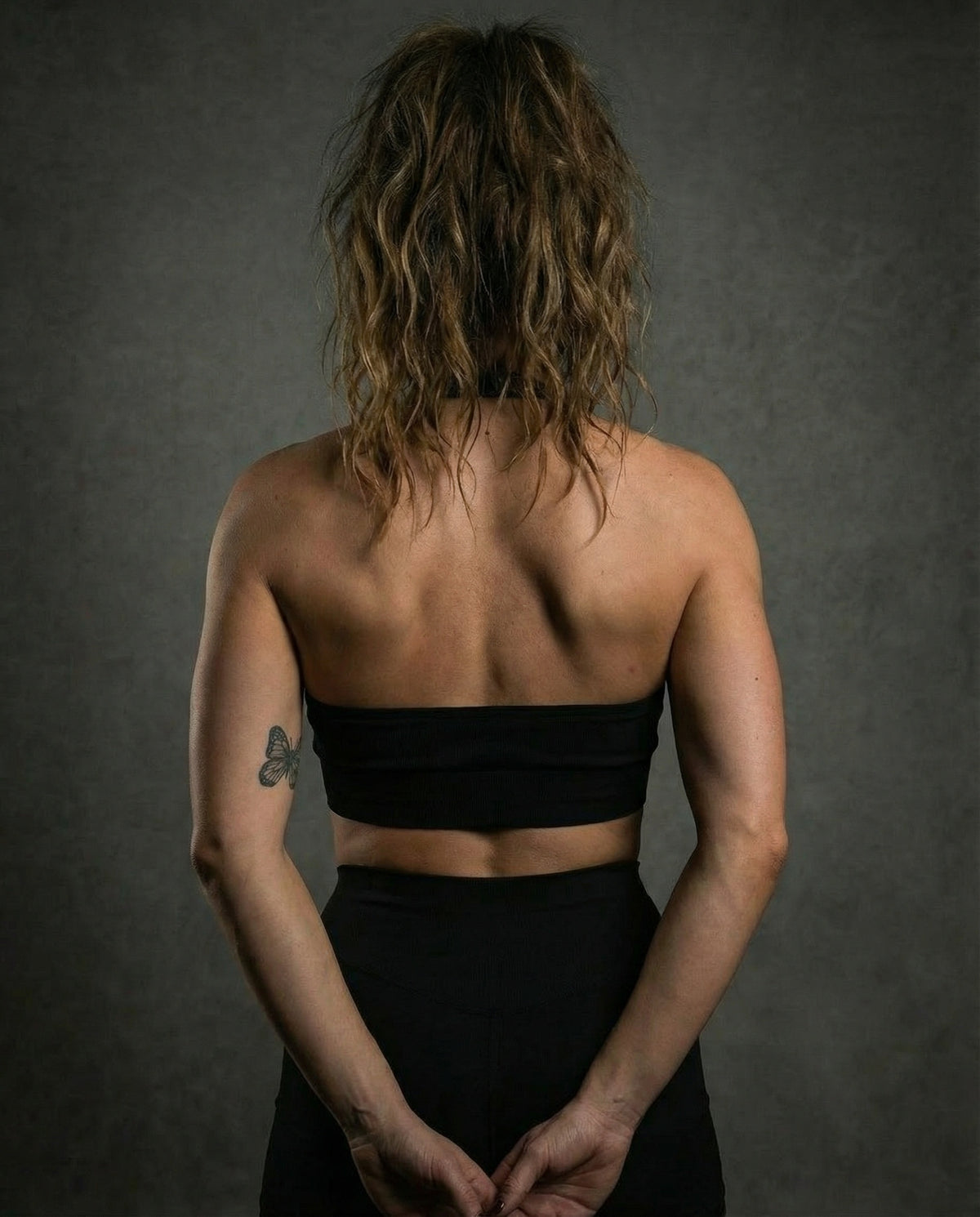 Halter sports bra in black, back view