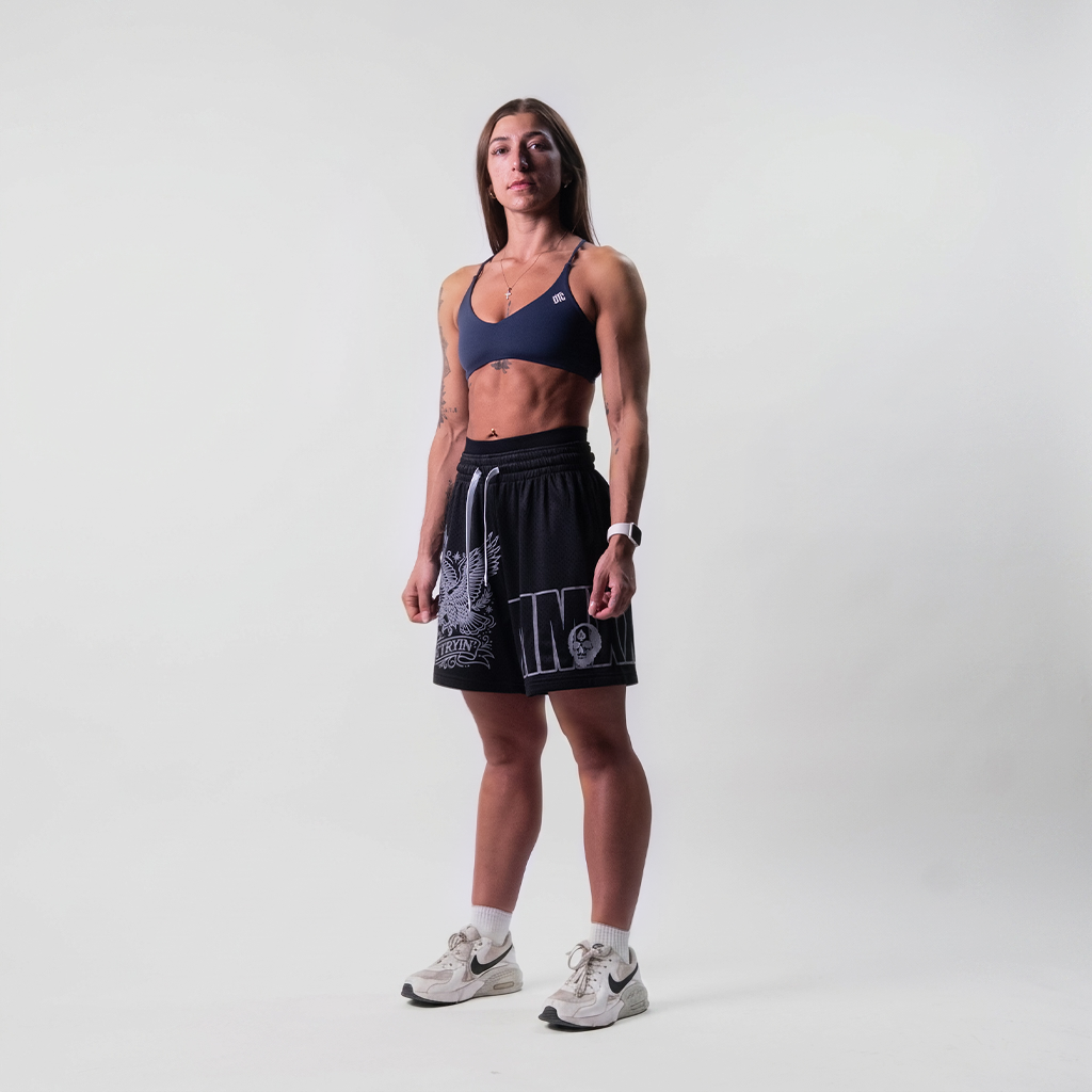 Black mesh training shorts worn, full length view