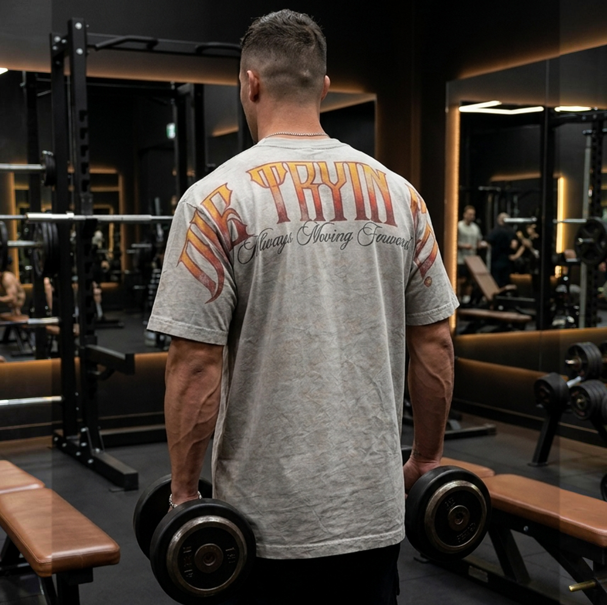 Oversized flame tee back graphic worn in a gym