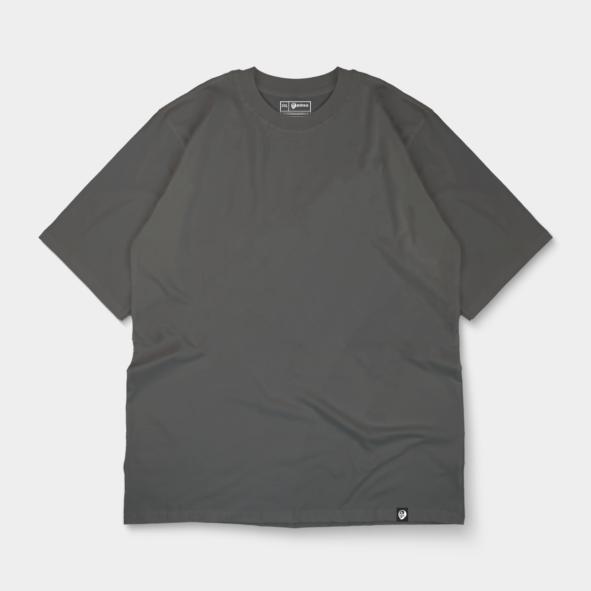 Oversized tagged tee flat lay in charcoal
