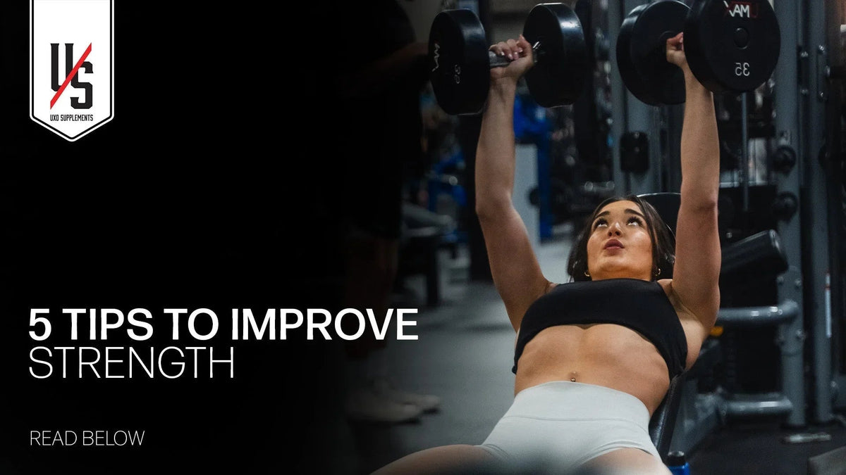 5 tips to improve strength: lifter pressing dumbbells on a flat bench