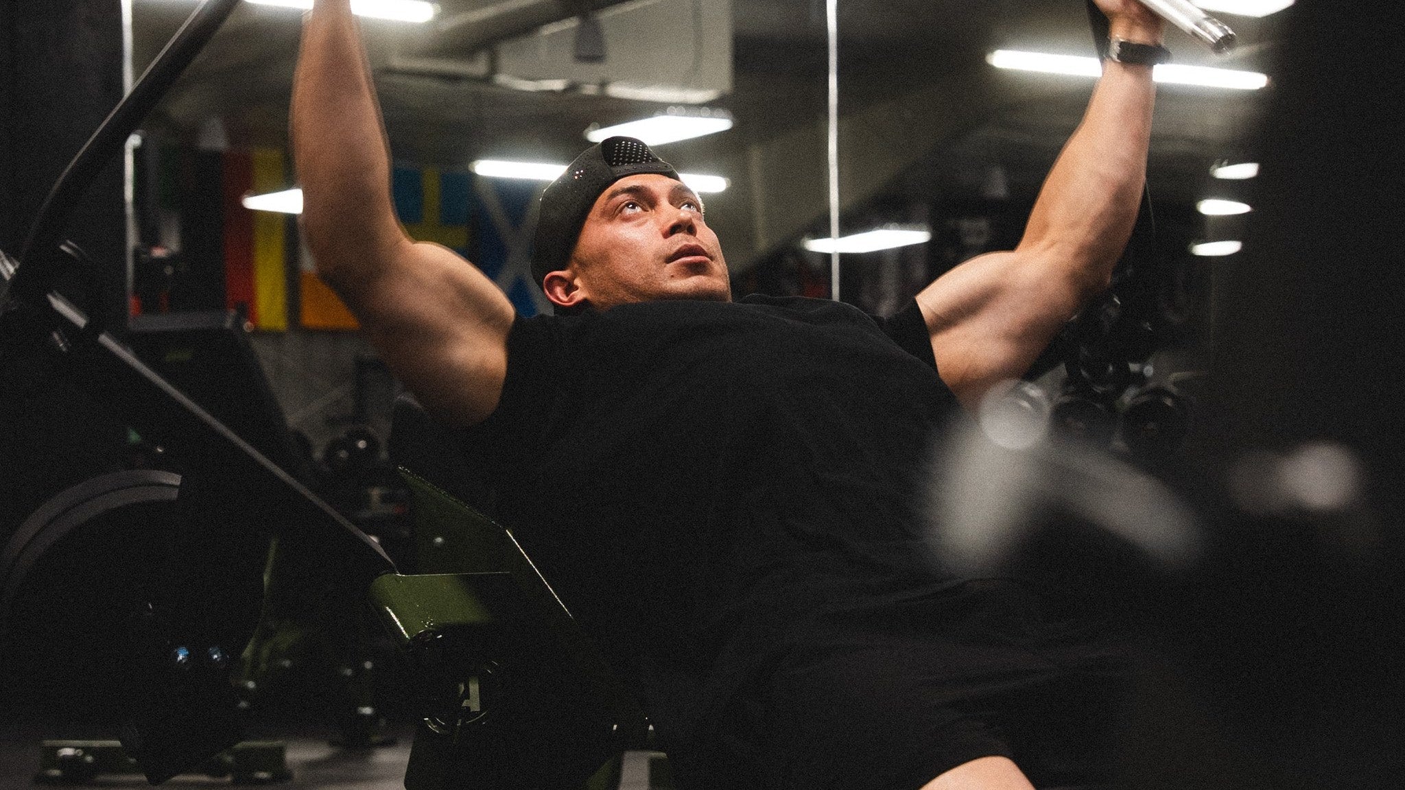 Lifter locked into a heavy incline press under low gym light