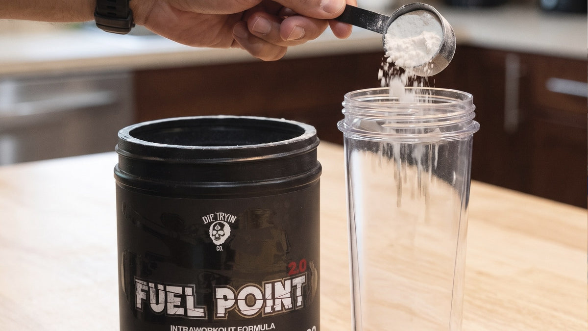 Scooping an intra-workout carbohydrate powder into a shaker cup