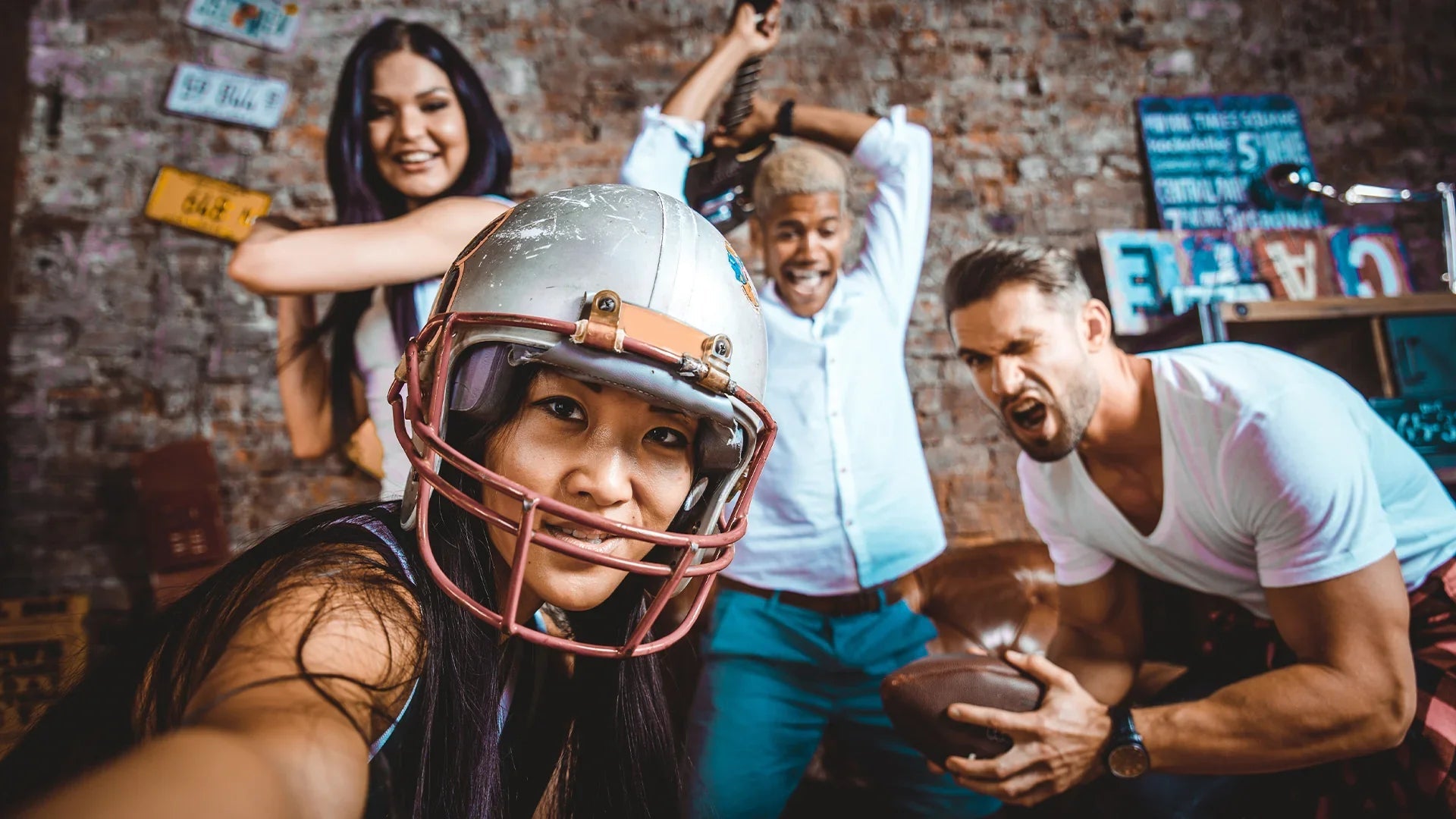 Friends celebrating during a Super Bowl party with football snacks