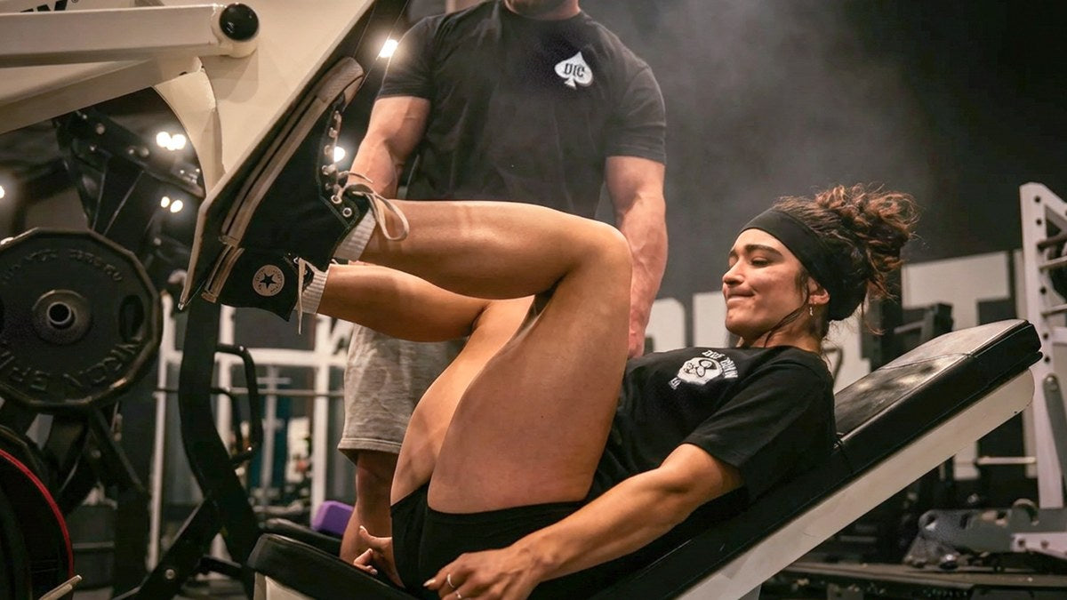 Athlete training hard with food and supplements staged beside the rack