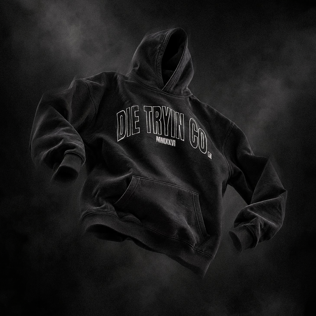 Black hoodie with an arched outlined Die Tryin Co. print floating against a dark smoky backdrop