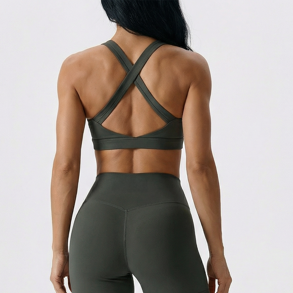 Performance sports bra in olive showing the crossed back straps