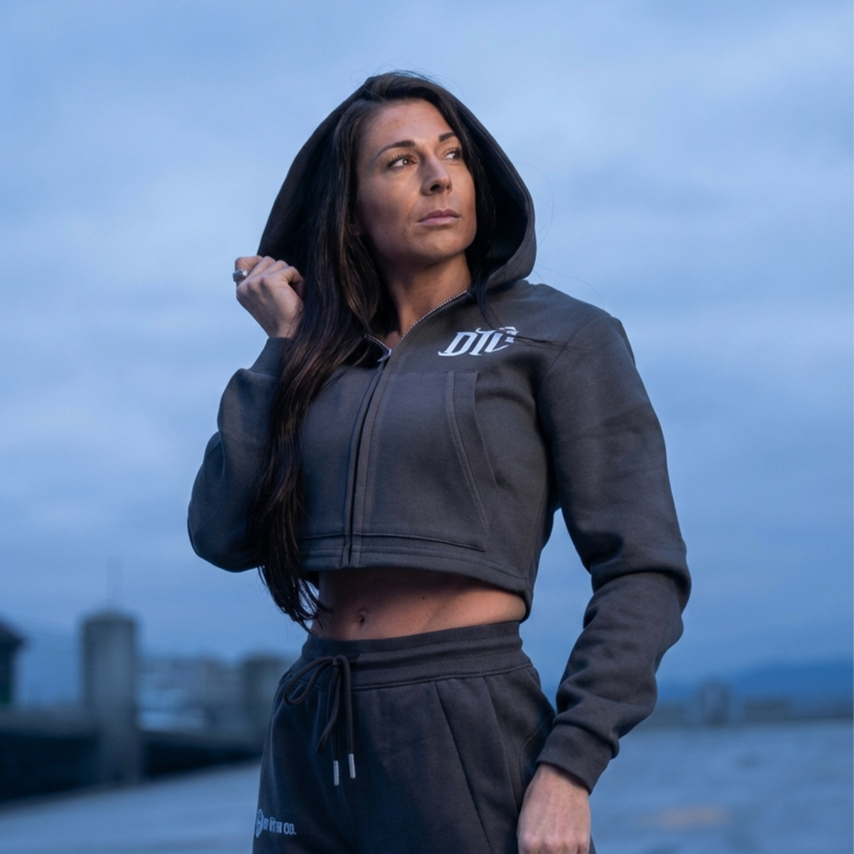 Women’s cropped zip hoodie in navy worn outdoors